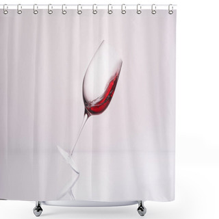 Personality  Inclined Wineglass With Red Wine On Reflective Surface And On White Shower Curtains
