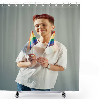 Personality  Redhead Queer Person In White T-shirt Holding Small LGTB Flags And Smiling With Closed Eyes On Grey Shower Curtains
