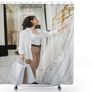 Personality  Stylish And Joyful Middle Eastern Woman With Brunette And Wavy Hair Standing In Beige Pants With White Shirt And Holding Shopping Bags While Choosing Wedding Dress In Bridal Boutique, Chic  Shower Curtains