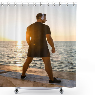 Personality  Rear View Of Athletic Adult Man In Headphones Standing On Seashore In Front Of Sunrise Shower Curtains