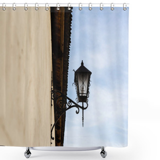 Personality  Low Angle View Of Vintage Lantern Made Of Forged Iron On Stone Wall Against Blue Sky In Lviv, Ukraine Shower Curtains