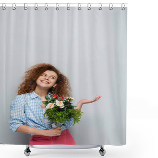 Personality  Cheerful Woman Looking Up And Pointing With Hand While Holding Flowers On Grey Background Shower Curtains