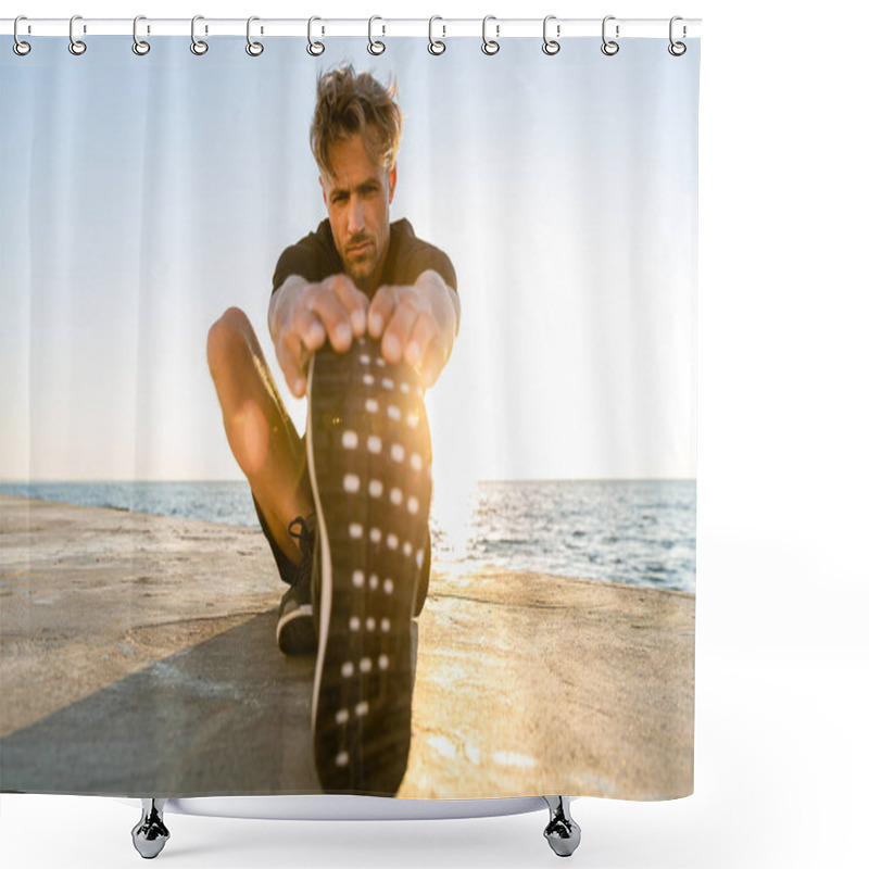 Personality  sporty adult man stretching leg on seashore in front of sunrise shower curtains