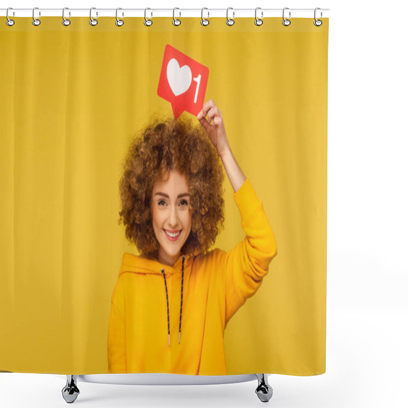 Personality  Internet Blogging. Portrait Of Happy Smiling Curly-haired Young Woman In Urban Style Hoodie Holding Heart Like Icon Over Head, Social Media Button. Indoor Studio Shot Isolated On Yellow Background Shower Curtains