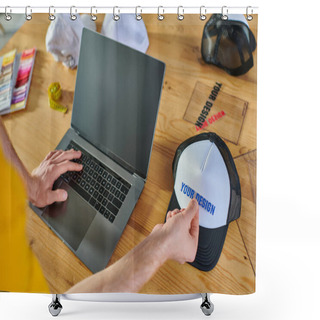Personality  Cropped View Of Designer Using Laptop With Blank Screen And Holding Printing Layer Near Snapback On Blurred Table In Print Studio, Hands-on Entrepreneurship Concept  Shower Curtains