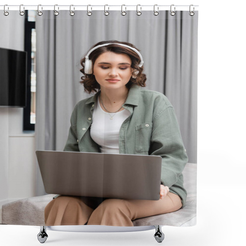 Personality  Young Woman With Wavy Brunette Hair, Casual Clothes And Wireless Headphones Sitting On Bed With Laptop During Educational Webinar Near Grey Curtains In Hotel Suite, Study And Travel Shower Curtains