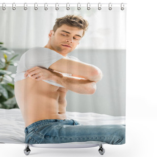 Personality  Handsome Man In Blue Jeans Sitting On Bed Near Window And Taking Off White T-shirt In Bedroom Shower Curtains