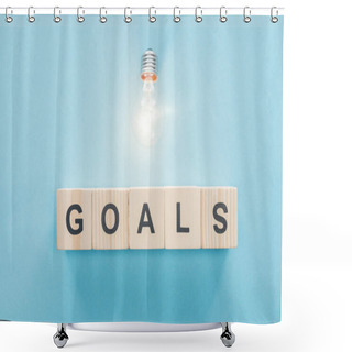 Personality  Top View Of Glowing Light Bulb Over 'goals' Word Made Of Wooden Blocks On Blue Background, Goal Setting Concept Shower Curtains