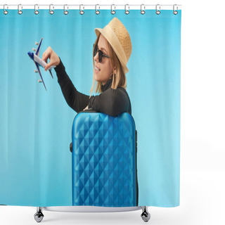 Personality  Blonde Happy Girl In Sunglasses And Straw Hat Plating With Toy Plane Near Blue Travel Bag Isolated On Blue Shower Curtains