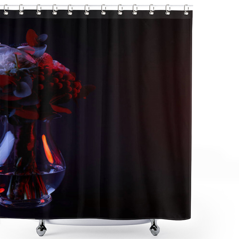 Personality  bouquet of different flowers in glass vase with red light on dark shower curtains