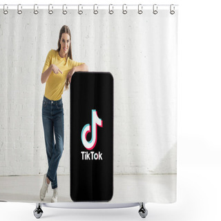 Personality  KYIV, UKRAINE - FEBRUARY 21, 2020: Happy Woman Looking At Camera While Pointing With Finger At Big Model Of Smartphone With TikTok App Shower Curtains
