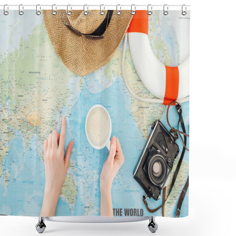 Personality  Cropped view of woman with cup of cappuccino, film camera, sunglasses and straw hat pointing with finger on world map shower curtains