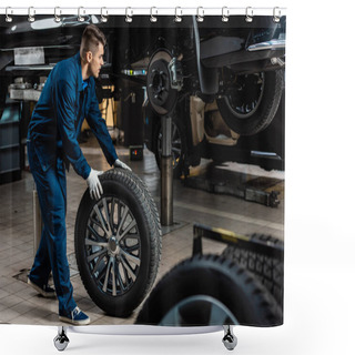 Personality  Young Mechanic Holding Car Wheel Near Raised Car In Workshop Shower Curtains