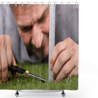 Personality  Close-up Of A Man Using Measuring Scale While Cutting Grass With Scissors Shower Curtains