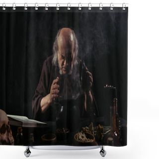 Personality  Alchemist In Dark Robe Looking Into Steaming Pot Near Herbal Ingredients On Black Background  Shower Curtains