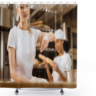 Personality  Happy Female Baker Kneading Dough And Pouring Flour On It At Baking Manufacture While Her Colleague Working Blurred On Background Shower Curtains