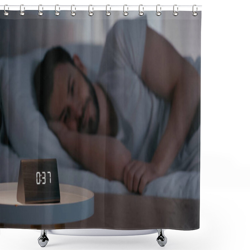 Personality  Clock on bedside table near blurred man lying on bed at night  shower curtains