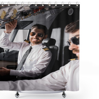 Personality  Cheerful Pilot In Sunglasses Reaching Overhead Panel Near Co-pilot In Airplane Simulator Shower Curtains