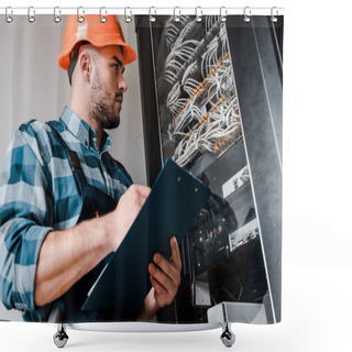 Personality  Low Angle View Of Bearded Man In Safety Helmet Holding Clipboard And Looking At Wires And Cables  Shower Curtains