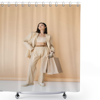 Personality  Full Length Of Asian Woman With Shopping Bags Posing In Stylish Ivory Pantsuit On Beige Background Shower Curtains