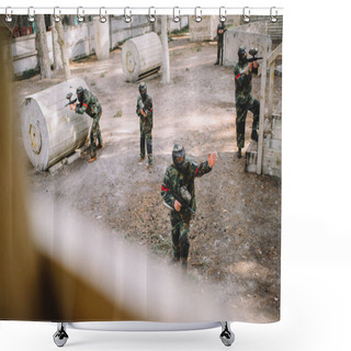 Personality  High Angle View Of Paintball Player In Uniform Pointing By Hand To His Team With Markers Guns Outdoors Shower Curtains