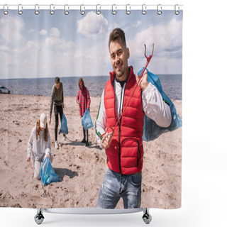 Personality  Cheerful Man Holding Trash Bag And Grabber Near Blurred Volunteers Collecting Rubbish On Sand  Shower Curtains