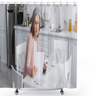 Personality  Grey Haired Mature Woman Holding Bills Near Laptop In Kitchen, Banner  Shower Curtains