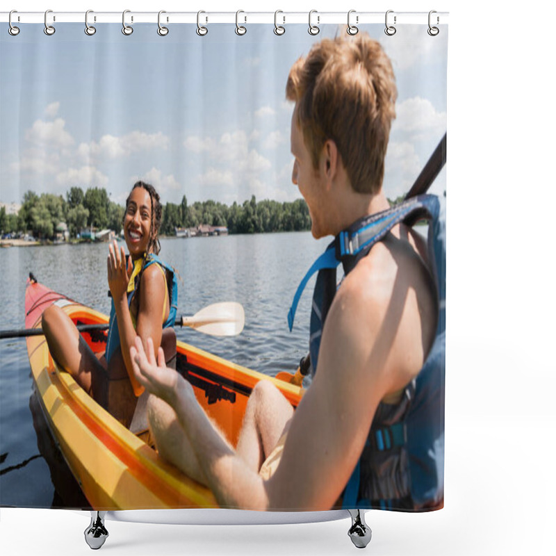 Personality  Pretty And Smiling African American Woman In Life Vest Looking At Blurred Redhead Man While Sailing In Sportive Kayak On River With Green Bank On Weekend In Summer Shower Curtains