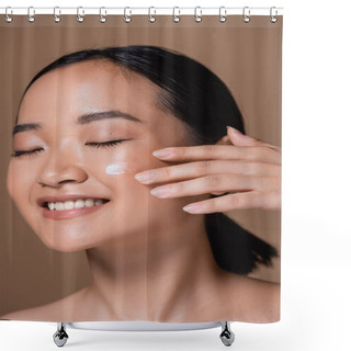 Personality  Smiling Asian Woman Applying Face Cream Isolated On Brown  Shower Curtains