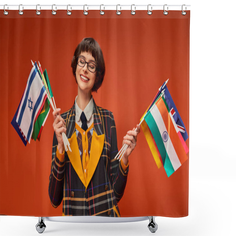 Personality  Happy College Girl In Her Uniform And Glasses Holding Multiple Flags And Standing On Orange Backdrop Shower Curtains
