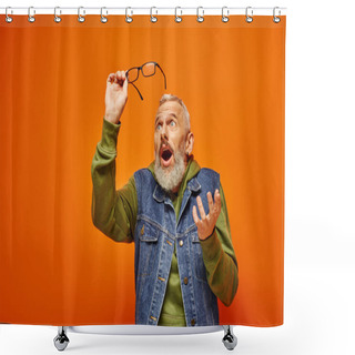 Personality  Good Looking Surprised Mature Man In Vivid Attire Holding Glasses And Posing On Orange Backdrop Shower Curtains