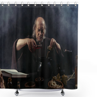 Personality  Senior Magician Pouring Liquid Into Pot While Preparing Potion On Black Background With Smoke Shower Curtains