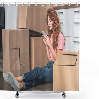 Personality  Attractive Woman With Curly Hair Sitting On Floor Near Cardboard Boxes And Using Smartphone At New Home Shower Curtains