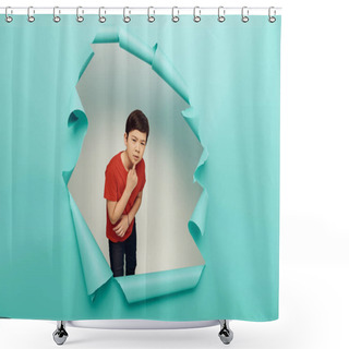 Personality  Pensive Asian Preteen Boy In Red T-shirt Looking At Camera During International Children Day Celebration While Standing Behind Hole In Blue Paper Background Shower Curtains