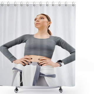 Personality  A Sporty Young Woman In Active Wear Confidently Stands With Hands On Hips Against A Grey Background. Shower Curtains