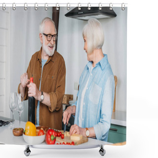 Personality  Happy Elderly Husband Looking At Wife Cutting Cheese While Opening Bottle Of Wine In Kitchen Shower Curtains