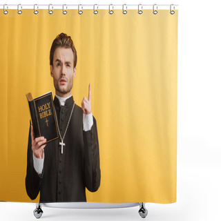 Personality  Thoughtful Catholic Priest Looking Up And Showing Idea Sign While Holding Open Bible Isolated On Yellow Shower Curtains