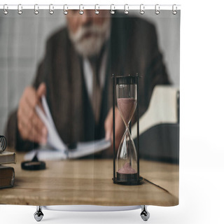 Personality  Senior Writer Working With Hourglass Standing On Foreground Shower Curtains