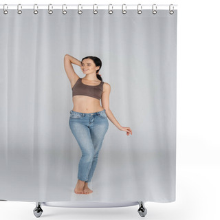 Personality  Smiling Woman In Jeans And Bra Looking Away While Posing On Grey Shower Curtains