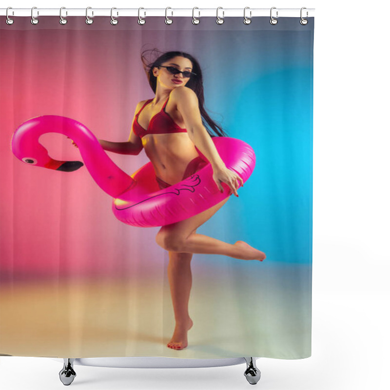 Personality  Fashion portrait of young fit and sportive woman with rubber flamingo in stylish red swimwear on gradient background. Perfect body ready for summertime. shower curtains
