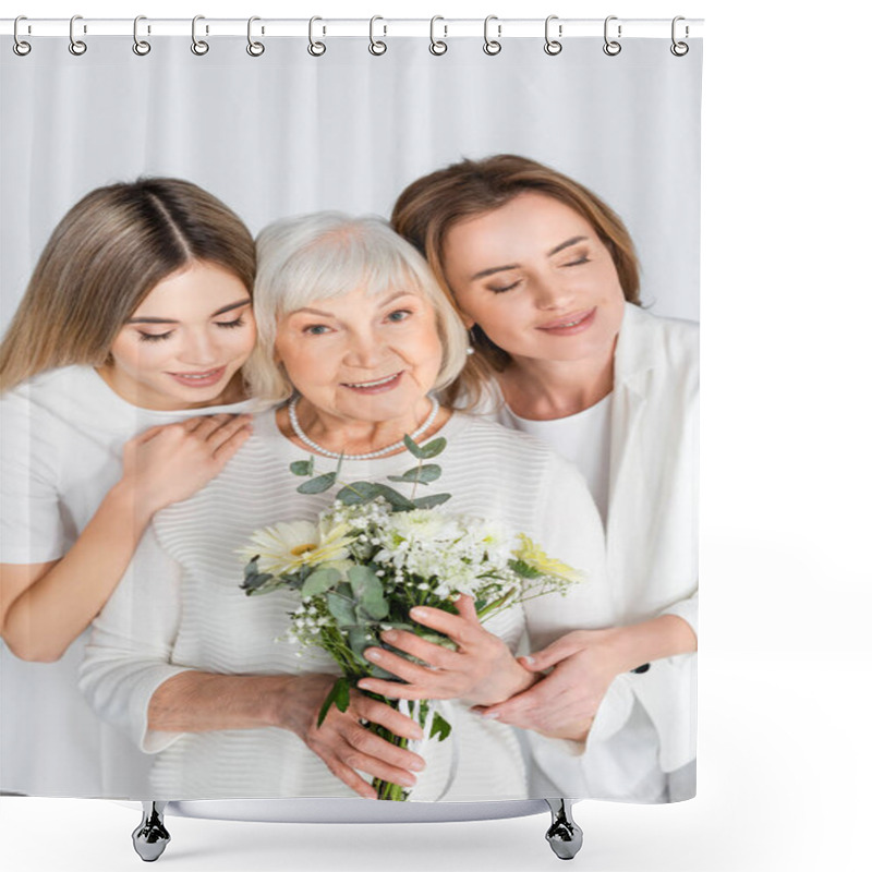 Personality  happy senior woman smiling while holding flowers near daughter and granddaughter isolated on white shower curtains