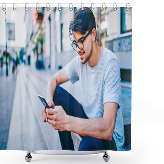 Personality  Cheerful Male Bogger Reading Funny Comments From Followers On Website On Smartphone With 4G Internet.Positive Hipster Guy In Eyewear Reading Notification With Good New On Telephone Sitting In Downtown Shower Curtains