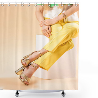 Personality  Cropped View Of Fashionable Girl In Yellow Trousers And Heeled Sandals Sitting On White Cube On Beige Shower Curtains