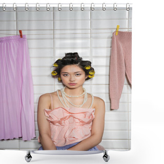 Personality  Asian Young Woman With Hair Curlers Standing In Pink Ruffled Top And Pearl Necklace Near Clean And Wet Laundry Hanging Near White Tiles, Housework, Housewife, Looking At Camera  Shower Curtains