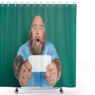 Personality  Astonished Overweight Man With Beard And Tattoos Taking Selfie On Blurred Smartphone Isolated On Green Shower Curtains