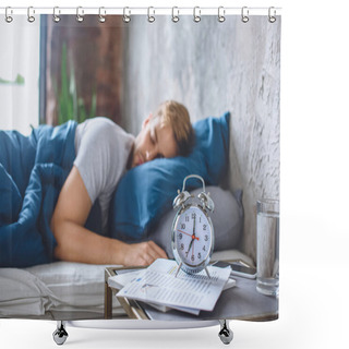 Personality  Selective Focus Of Alarm Clock And Sleeping Man In Bed Behind  Shower Curtains