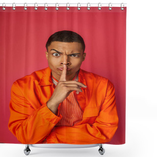 Personality  Strict African American Man In Orange Shirt Looking At Camera And Showing Hush Gesture On Red Shower Curtains