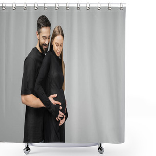 Personality  Positive Bearded Husband In T-shirt Hugging Belly Of Stylish And Pregnant Wife In Black Dress While Standing Together Isolated On Grey With Copy Space, Growing New Life Concept Shower Curtains