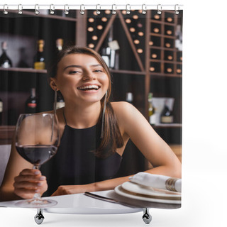 Personality  Selective Focus Of Excited Woman Holding Glass Of Wine While Looking At Camera At Table In Restaurant  Shower Curtains