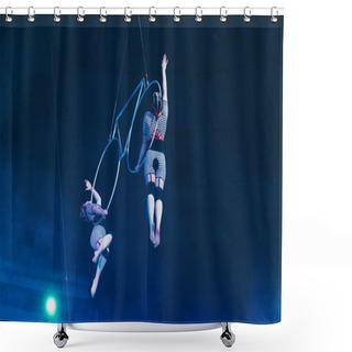 Personality  KYIV, UKRAINE - NOVEMBER 1, 2019: Low Angle View Of Air Gymnasts Performing With Metal Rings In Circus Shower Curtains